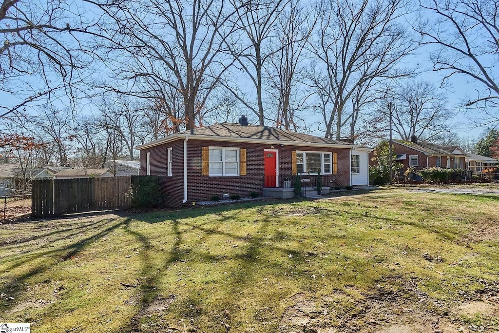 1 Picadilly St, Taylors, SC 29687 - view of front of home featuring brick siding, fence, and a front lawn