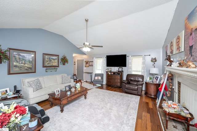 100 Sonora Dr, Easley, SC 29640 - living room with ceiling fan, a fireplace, a textured ceiling, wood finished floors, and lofted ceiling