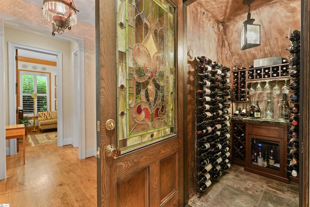 wine room featuring baseboards and wood finished floors