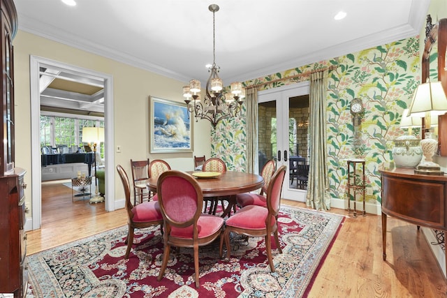 dining area featuring wallpapered walls, french doors, crown molding, and wood finished floors