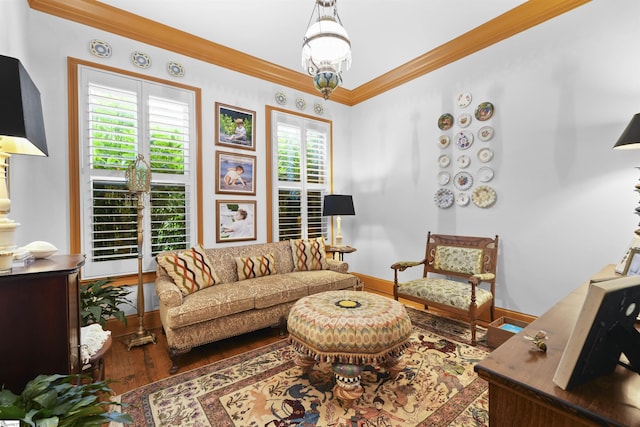 living room with crown molding, baseboards, and wood finished floors