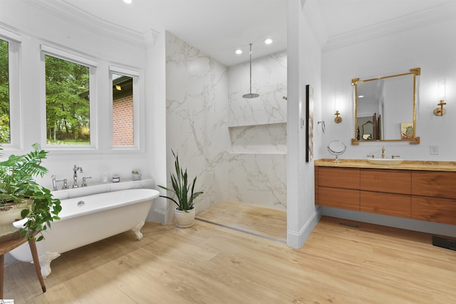 bathroom featuring vanity, crown molding, a marble finish shower, and wood finished floors