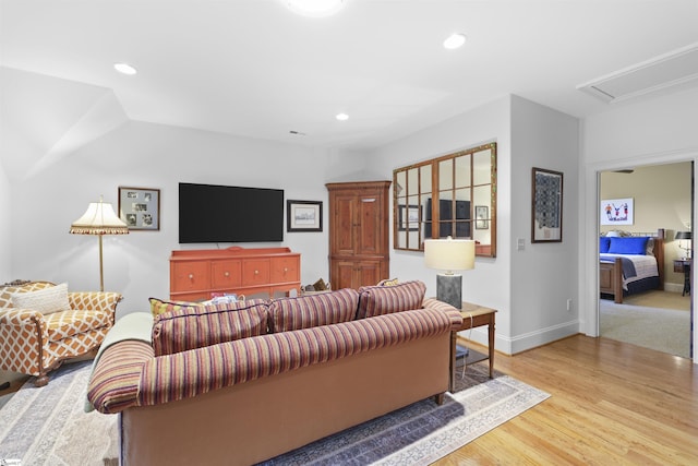 living room with light wood-type flooring, baseboards, and recessed lighting