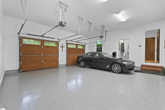 garage with baseboards and a garage door opener
