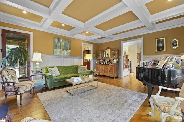 living area featuring coffered ceiling, light wood-style floors, and beamed ceiling