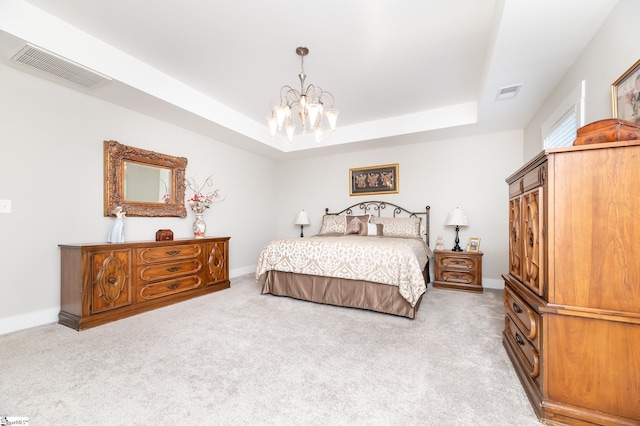 bedroom featuring a tray ceiling, visible vents, and carpet floors