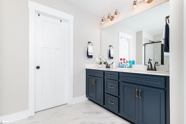 bathroom featuring a sink, a shower stall, marble finish floor, and double vanity