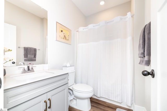 bathroom featuring toilet, wood finished floors, vanity, and a shower with shower curtain