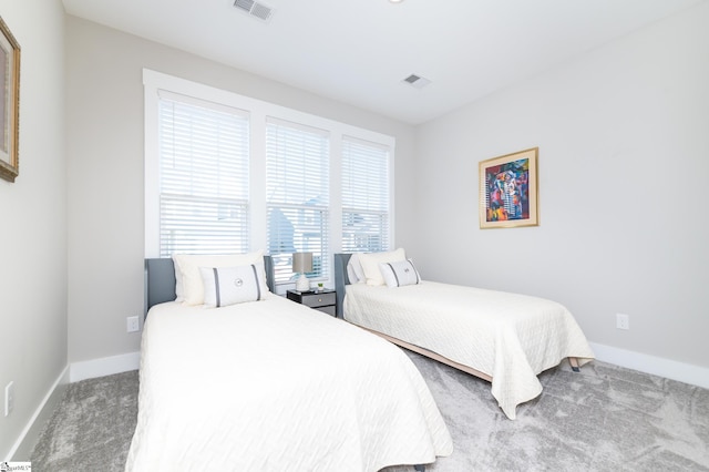bedroom featuring baseboards, carpet, and visible vents