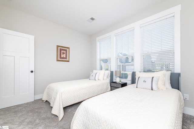 bedroom with carpet floors, baseboards, and visible vents