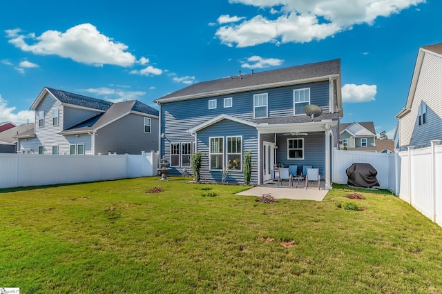 back of property with a patio, a fenced backyard, and a lawn