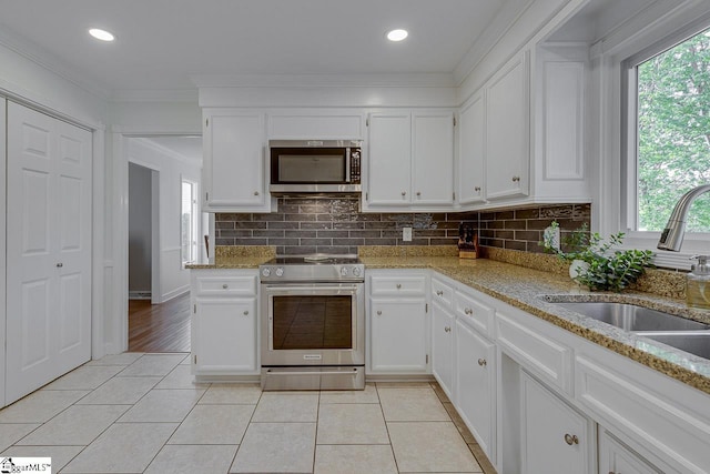 105 Berrywood Ct, Greer, SC 29650 - kitchen featuring a sink, light tile patterned floors, a healthy amount of sunlight, and appliances with stainless steel finishes