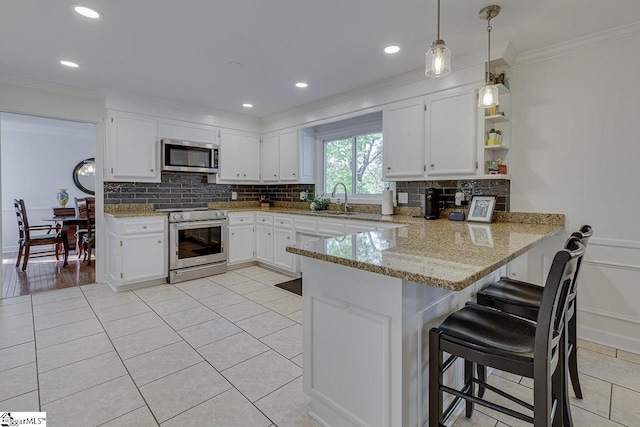 105 Berrywood Ct, Greer, SC 29650 - kitchen featuring a peninsula, light tile patterned floors, backsplash, appliances with stainless steel finishes, and ornamental molding