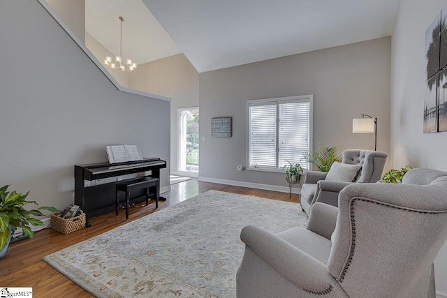 105 Berrywood Ct, Greer, SC 29650 - living area featuring baseboards, a notable chandelier, high vaulted ceiling, and wood finished floors