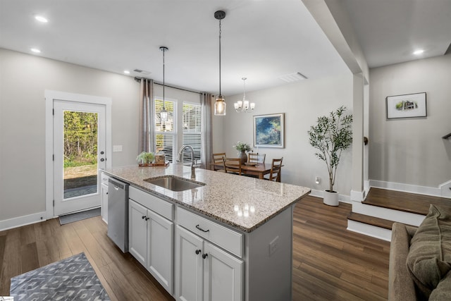 kitchen featuring a sink, visible vents, stainless steel dishwasher, and dark wood finished floors