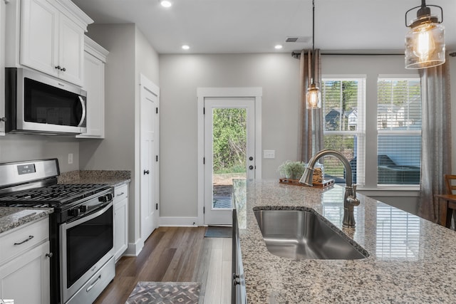 kitchen featuring a sink, appliances with stainless steel finishes, dark wood finished floors, recessed lighting, and white cabinetry
