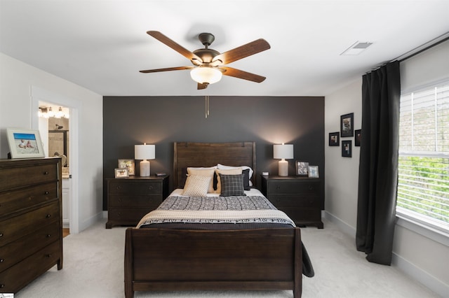 bedroom featuring ceiling fan, light colored carpet, baseboards, and visible vents