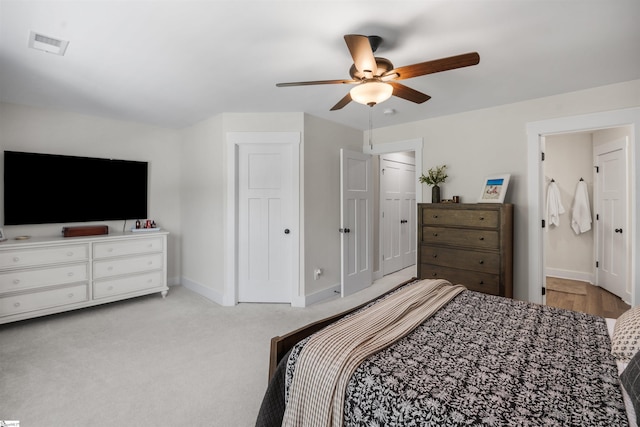 bedroom featuring visible vents, baseboards, a ceiling fan, and carpet floors