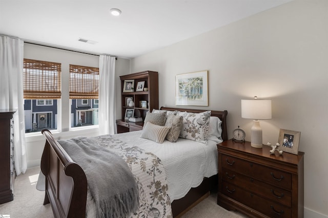 bedroom with visible vents and light colored carpet