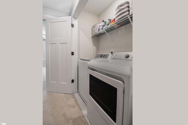 clothes washing area with separate washer and dryer and laundry area
