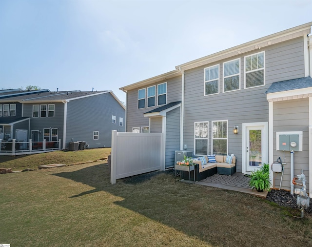 rear view of house with an outdoor living space, cooling unit, fence, and a lawn