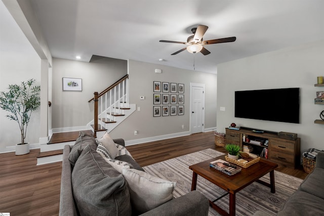 living area with ceiling fan, stairs, wood finished floors, and baseboards