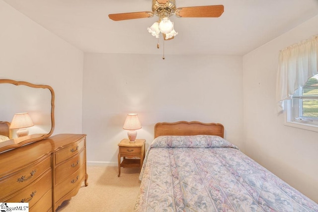 bedroom featuring baseboards, a ceiling fan, and light colored carpet