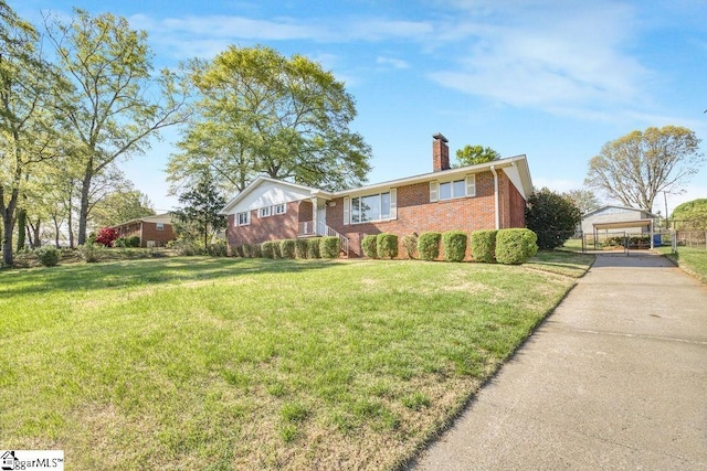 ranch-style home featuring concrete driveway, a carport, a chimney, a front lawn, and brick siding