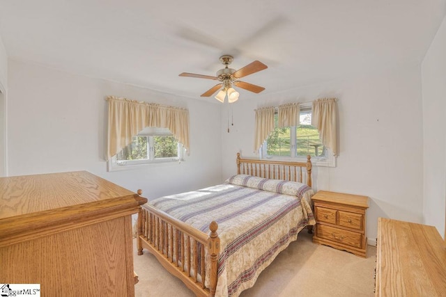 bedroom featuring a ceiling fan and light colored carpet
