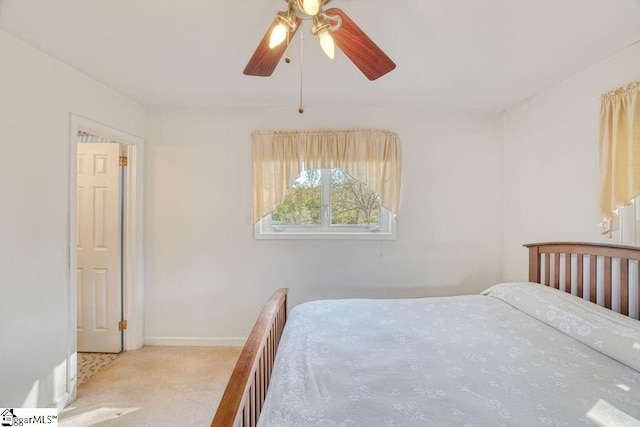 bedroom with carpet flooring, baseboards, and a ceiling fan