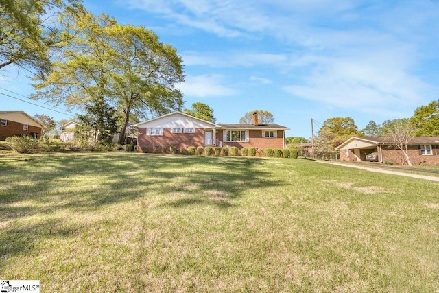 view of front of property with a chimney and a front lawn