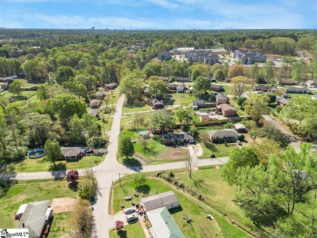 birds eye view of property featuring a wooded view and a residential view