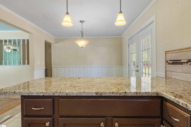 105 Pinewood Ave, Clinton, SC 29325 - kitchen featuring crown molding, light stone counters, and dark brown cabinetry