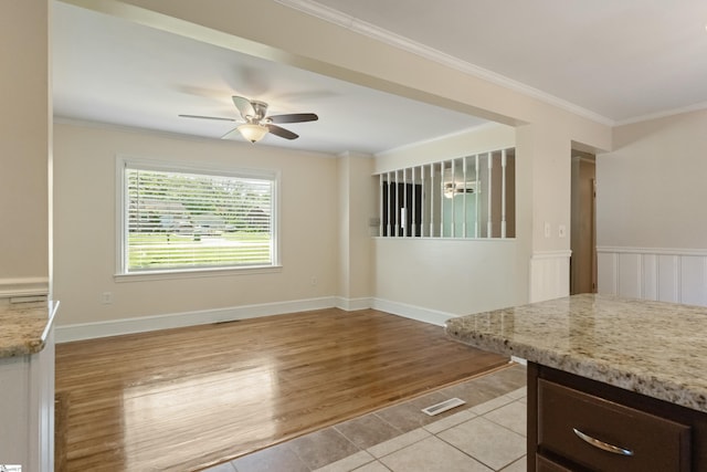 105 Pinewood Ave, Clinton, SC 29325 - unfurnished room featuring light tile patterned floors, ornamental molding, a wainscoted wall, and ceiling fan