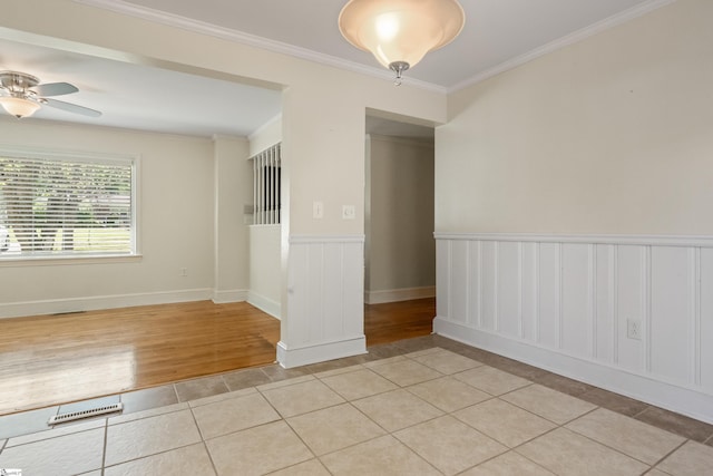 105 Pinewood Ave, Clinton, SC 29325 - empty room featuring a ceiling fan, crown molding, light tile patterned floors, and wainscoting