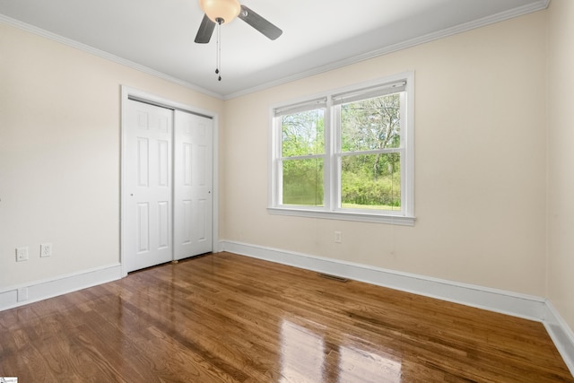 105 Pinewood Ave, Clinton, SC 29325 - unfurnished bedroom with visible vents, baseboards, ornamental molding, and wood finished floors