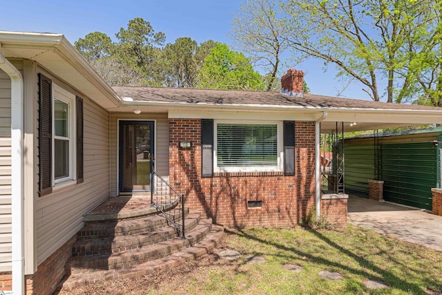 105 Pinewood Ave, Clinton, SC 29325 - view of front of home with a carport, brick siding, a chimney, and a front yard