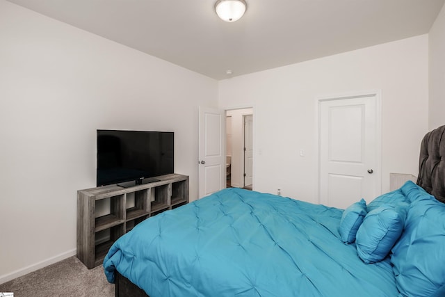 carpeted bedroom featuring baseboards