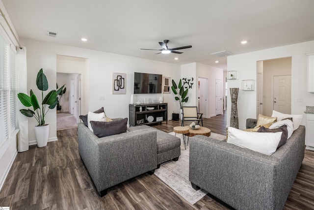 living room featuring dark wood-style flooring, a ceiling fan, visible vents, and recessed lighting