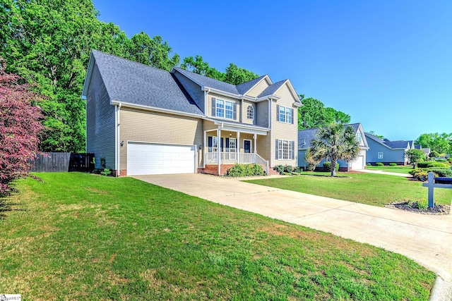 traditional-style house with concrete driveway, an attached garage, fence, and a front lawn