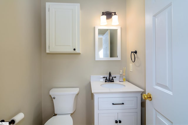 bathroom featuring toilet and vanity