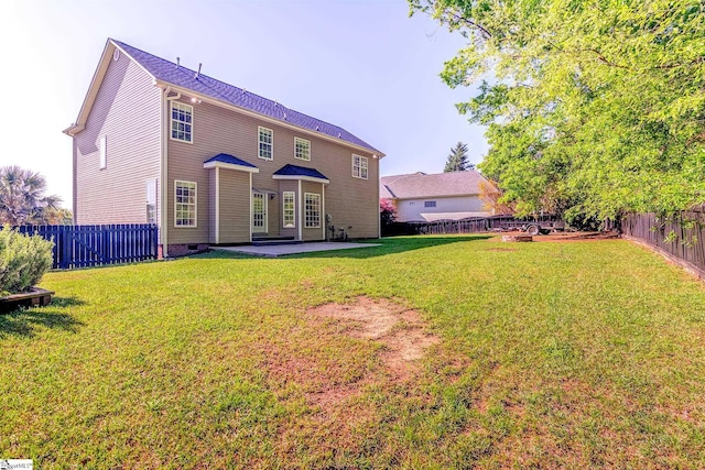 back of house featuring a patio area, crawl space, a fenced backyard, and a lawn