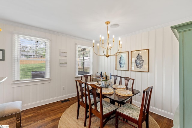dining area with baseboards, ornamental molding, a chandelier, visible vents, and dark wood finished floors
