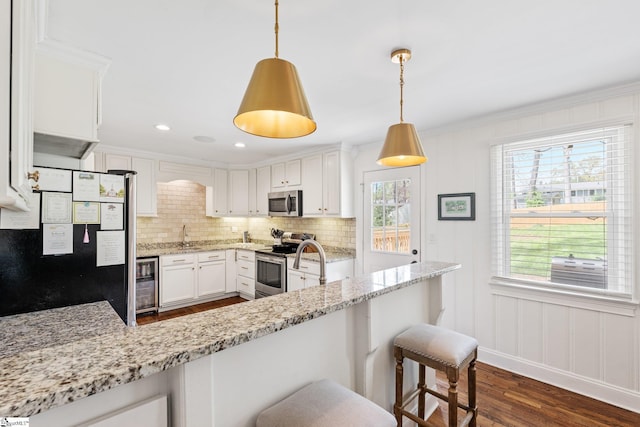 kitchen with tasteful backsplash, dark wood-style floors, wine cooler, light stone countertops, and stainless steel appliances