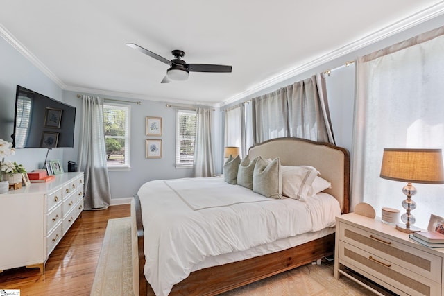 bedroom with crown molding, light wood-style flooring, ceiling fan, and baseboards