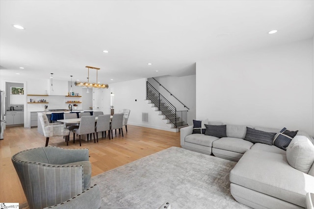 living room with recessed lighting, stairway, visible vents, and light wood-type flooring