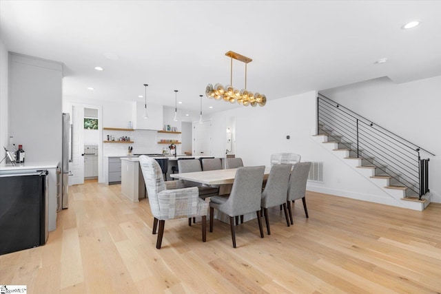 dining space featuring visible vents, baseboards, light wood-type flooring, recessed lighting, and stairs