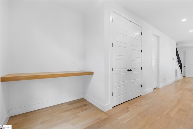 hallway with light wood-style floors, visible vents, recessed lighting, stairway, and baseboards