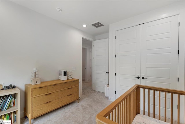 bedroom with a closet, baseboards, recessed lighting, visible vents, and light colored carpet