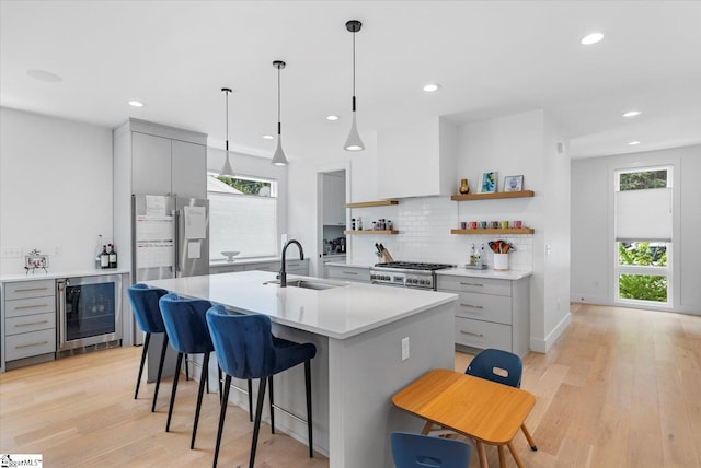 kitchen with gray cabinets, wine cooler, stainless steel fridge with ice dispenser, and a sink